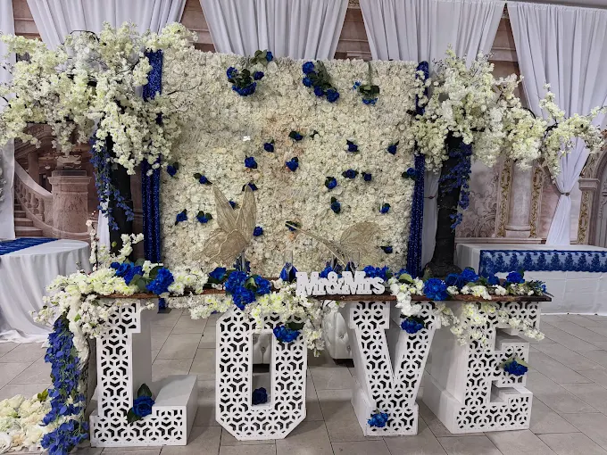 Blue and white wedding backdrop with LOVE marquee letters and flower wall at Lavender Venue