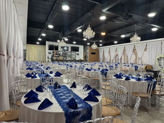 Royal blue reception setup with crystal chandeliers and bar area at Lavender Venue